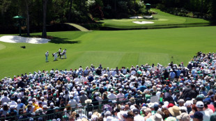 Adoring Augusta cheers Tiger into another Masters weekend