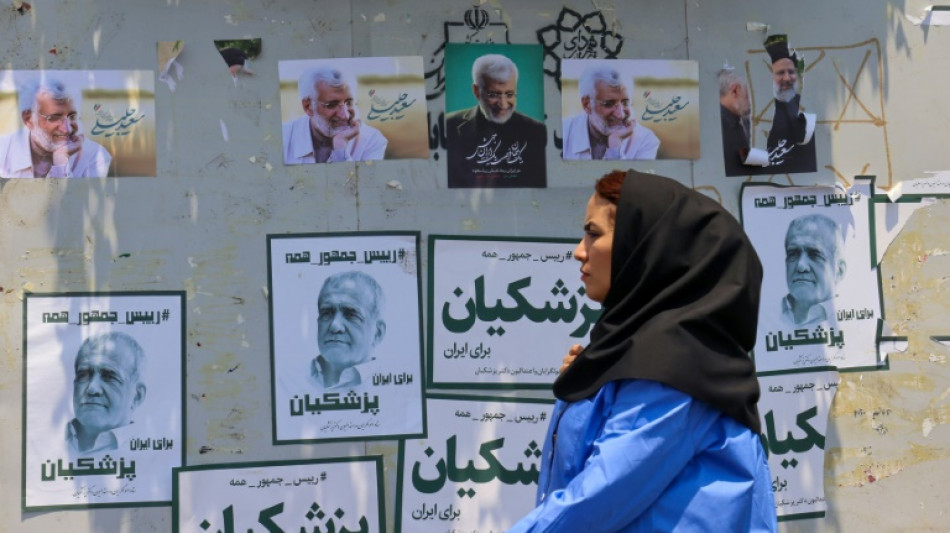 Iranians split on presidential vote as hardships mount