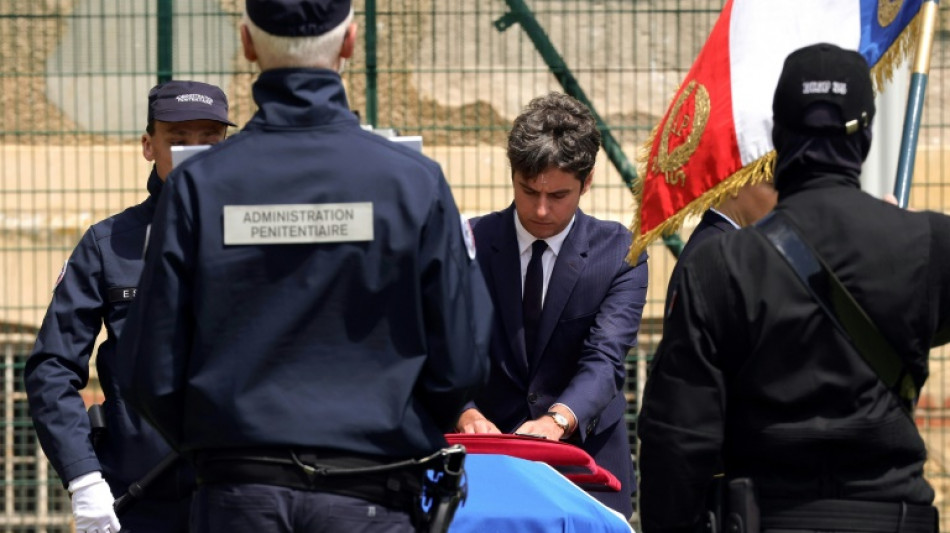 France pays tribute to prison officers, attackers still at large