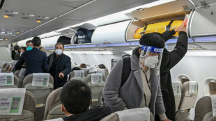 China ends quarantine for overseas travellers