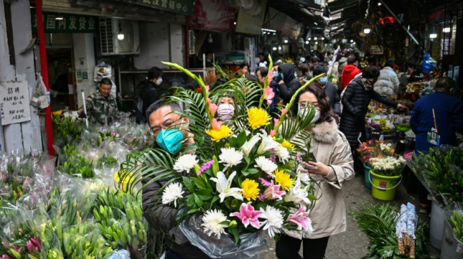 Bustling Wuhan markets celebrate New Year but grief remains